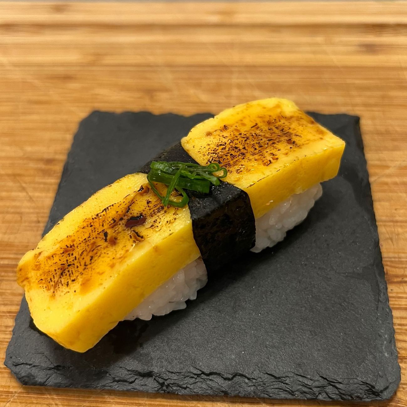 Tamagoyaki Nigiri.
This cut of Tamagoyaki (Grilled Japanese Omelet) is brushed with a chili oil, shoyu, & fish sauce mixture, which is added before being slightly torched. It’s then topped with a bit of scallion.
Need A Private Sushi Chef???
My name is Julian & I specialize in providing an Omakase (Chef’s Choice) experience throughout Southern California!
I mainly work around my own interpretation of traditional Japanese sushi, with a slight hint of French & Peruvian inspired flavors!
Follow me @asurfersushichef??♂️
Check out my website: www.asurfersushichef.com?
(Link In Bio)⬆️?
Available for private events hosted in Santa Barbara, Ventura, Los Angeles, Orange, and San Diego County!
Please DM me for menu inquiries or any other questions!
#asurfersushichef #sushi #sashimi #maki #omakase #sushicatering #sushichef #surfing #privateomakase #tamago #tamagoyaki #tamagonigiri