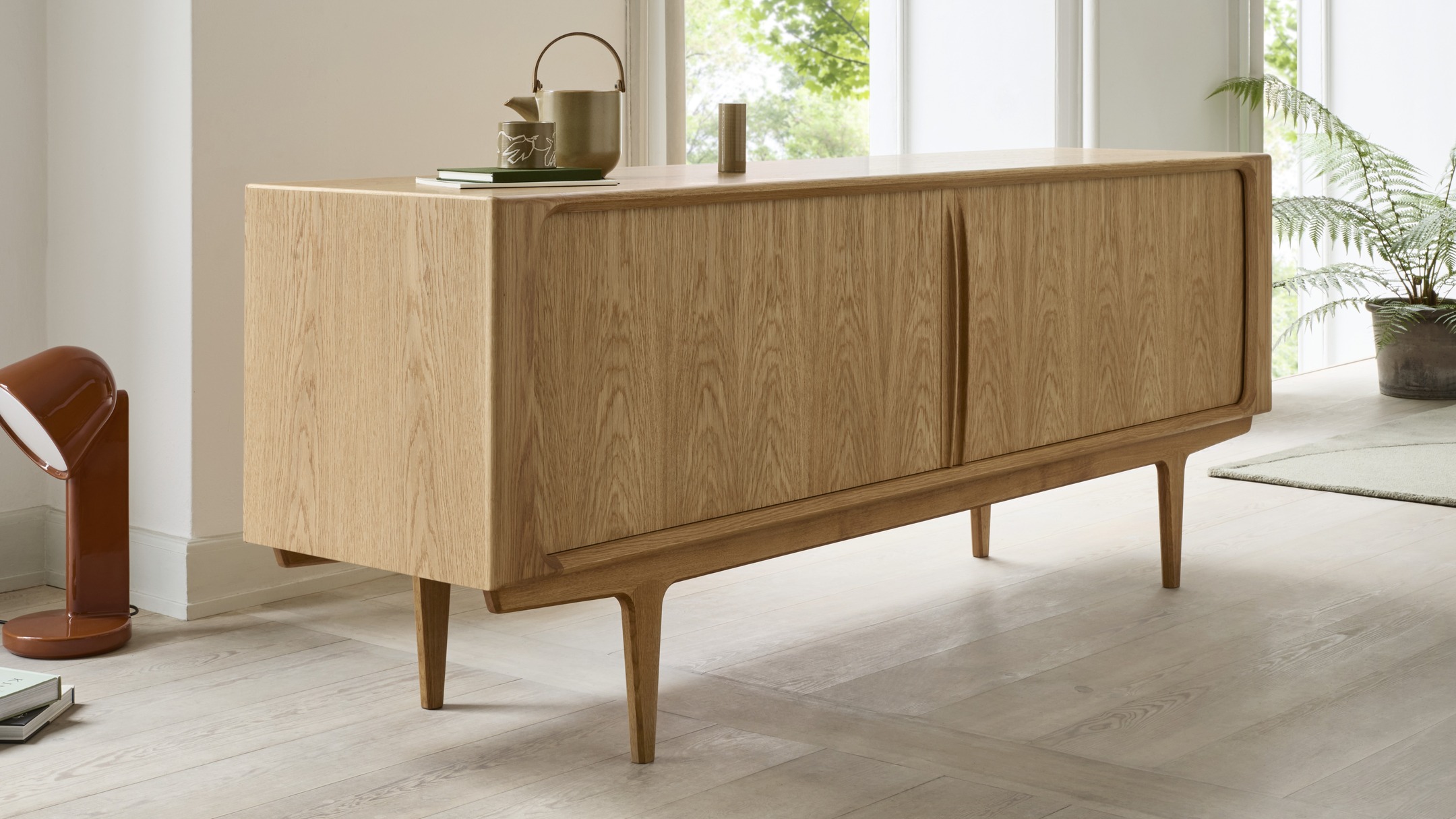 BPS142 | SIDEBOARD – A TRUE DANISH MODERN CLASSIC
Designed in 1965, Sideboard No. 142 captures the essence of Danish Modern with its clean lines, functional design and outstanding cabinetmaking.
Featuring beautifully crafted tambour (roller shutter) doors that roll seamlessly into the back, this sideboard combines refined aesthetics with practical storage.
A rare technique today — both visually striking and highly space-efficient.
Inside, you’ll find adjustable shelves on each side and a central section that can be configured with shelves or solid wood dovetail trays.
The legs are subtly pulled under to allow placement close to the wall, and with its veneered back, the sideboard also works beautifully as a room divider.
Available in two lengths and made in Denmark, every piece is individually numbered on final assembly — a true testament to quality and craftsmanship.
A timeless piece for contemporary and classic interiors alike.
Made in Denmark.
Designed by BPS Design Studio.
#danishdesign #midcenturymodern #cabinetmaking #tambourdoors #madeindenmark #timelessdesign #bernhardpedersenandson