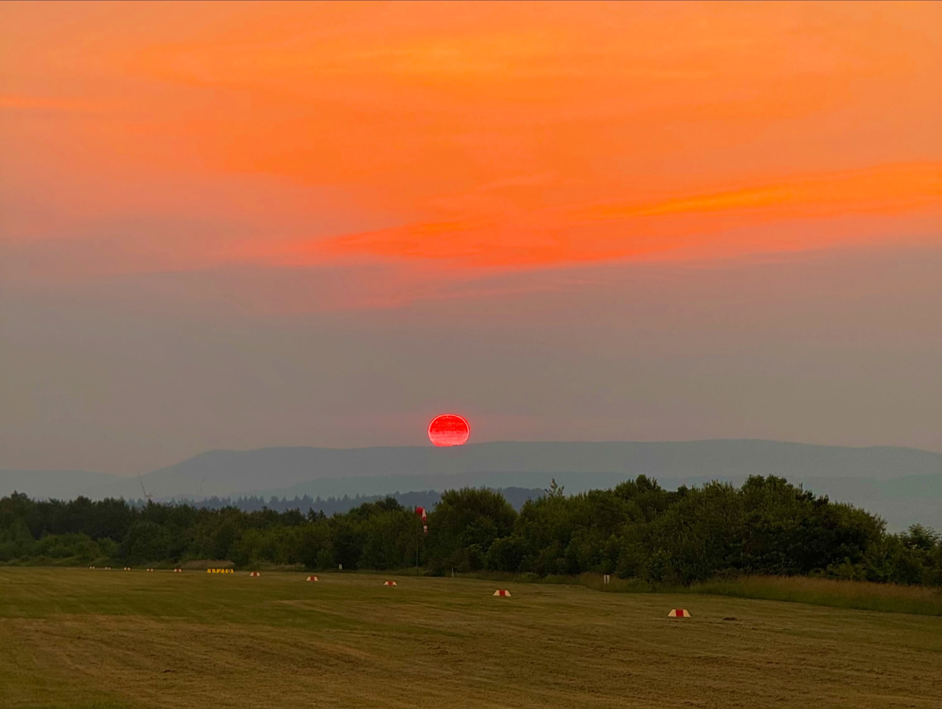 Gestern am längsten Tag des Jahres haben unsere Segelflieger ein Sonnenaufgangsfliegen veranstaltet. Geplant waren die ersten Starts pünktlich zum Sonnenaufgang um 05:03 Uhr. Bereits kurz nach dem ersten Start machte sich jedoch aus Südwesten eine Gewitterfront bemerkbar, die mit hoher Geschwindigkeit auf unseren Flugplatz zuzog. ⛈️
Nach nur zwei Starts musste der Flugbetrieb aus Sicherheitsgründen beendet werden und alle Flugzeuge wurden zügig wieder in den Hallen untergebracht.
Trotz des vorzeitigen Endes möchten wir euch die beeindruckenden Eindrücke dieses besonderen Morgens natürlich nicht vorenthalten. Viel Spaß mit den folgenden Bildern! ✈️🌄🌅